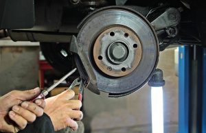 hands fixing a vehicle brake