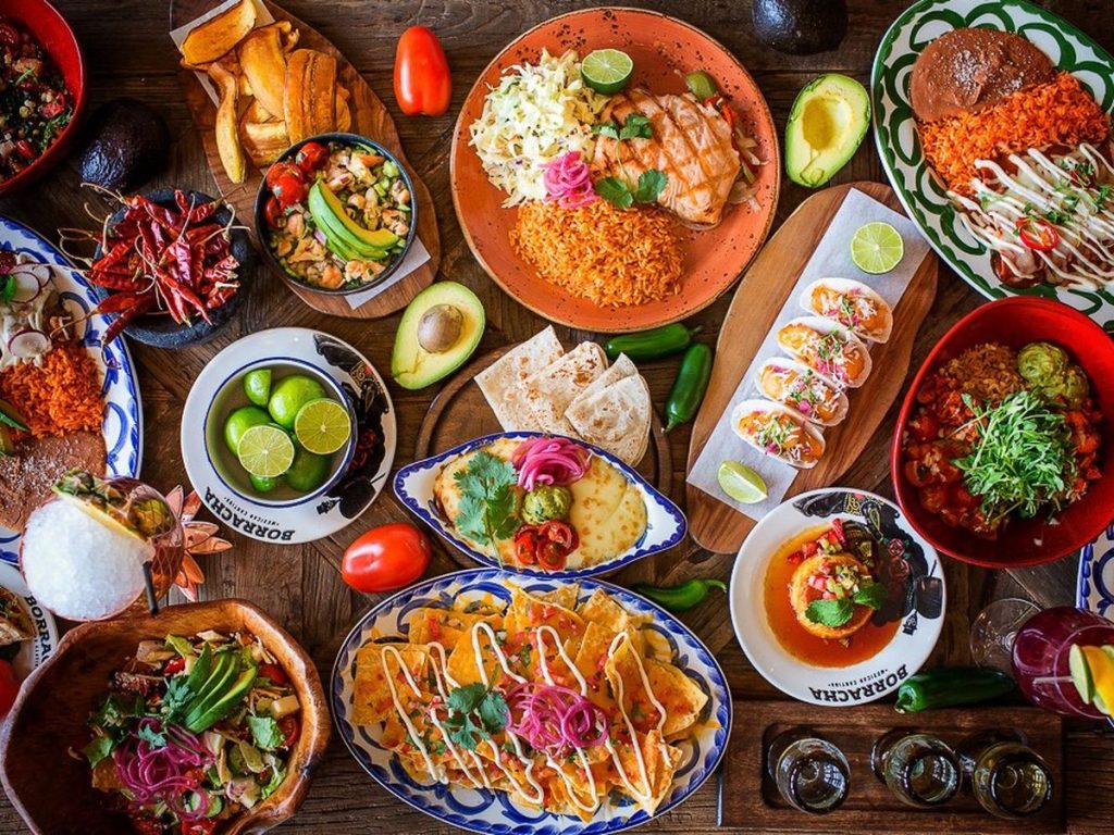 Aerial photograph of a whole lot of Mexican cuisine that covers the entire table with wonder colors.